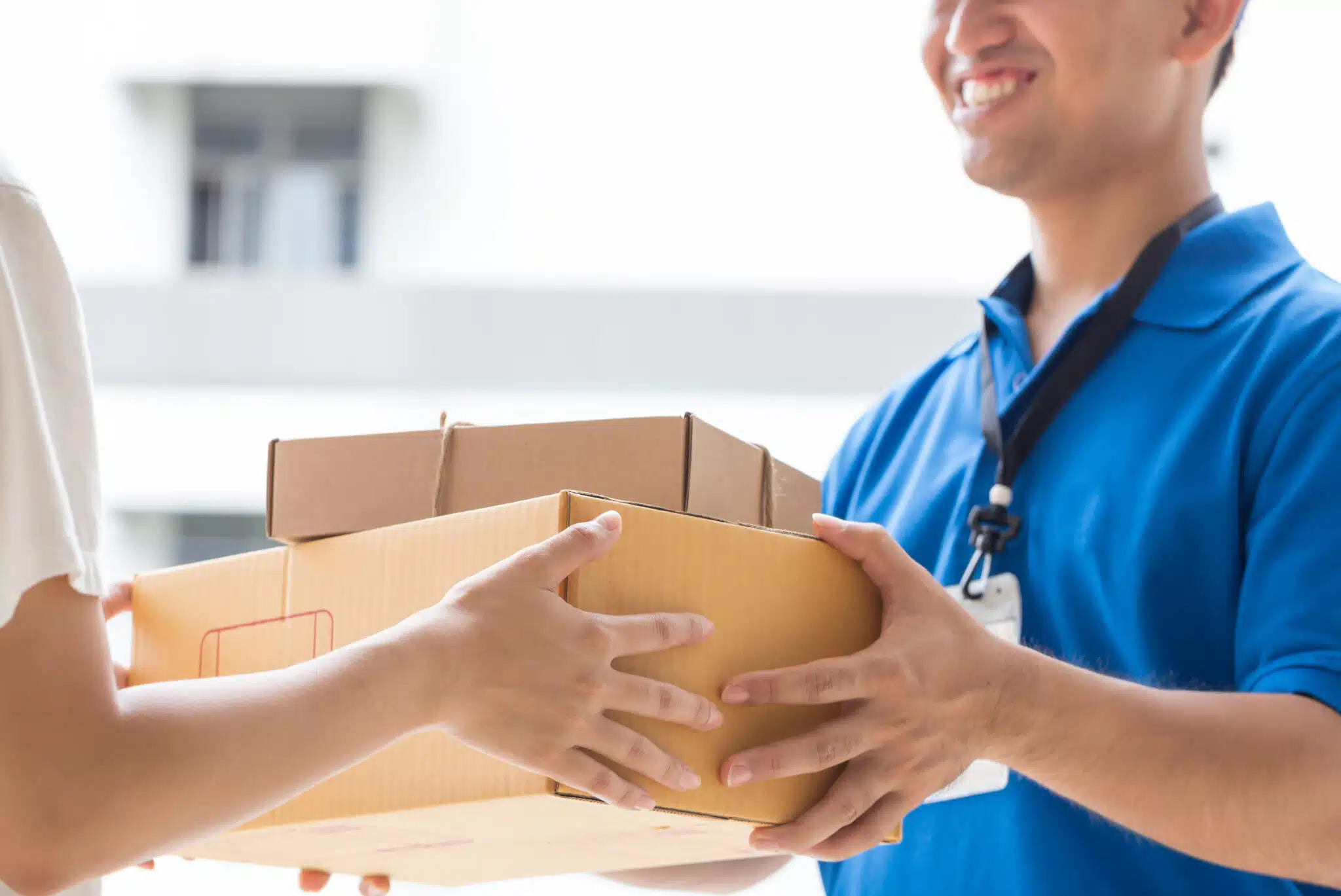 What Makes Us Different img Courier delivering a cardboard package to a customer