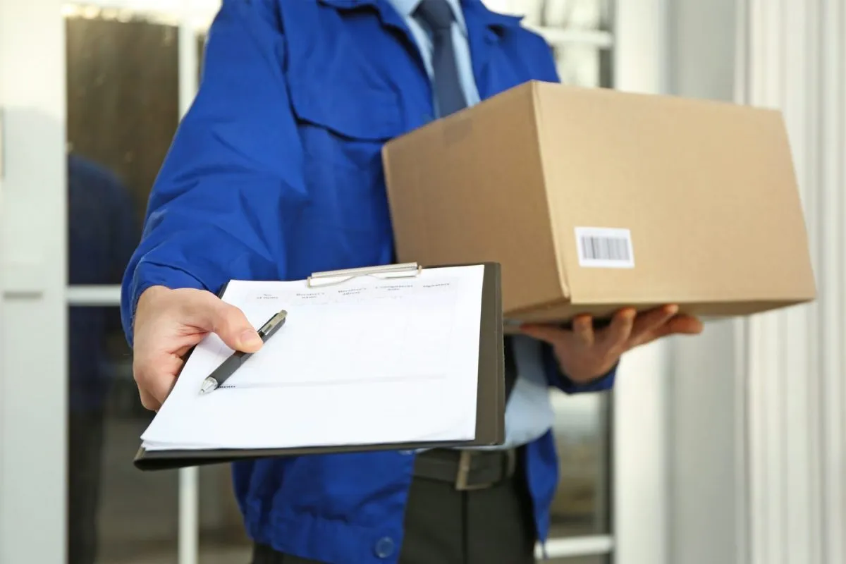 Why Choose Us img Professional courier holding a package and delivery documentation
